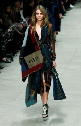 Cara Delevingne presents a creation from the Burberry Prorsum Autumn/Winter 2014 collection...