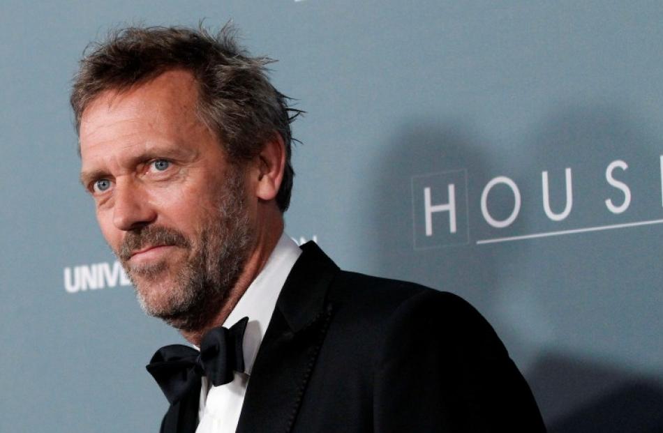 Cast member Hugh Laurie poses as he arrives at the series finale wrap party of the television...