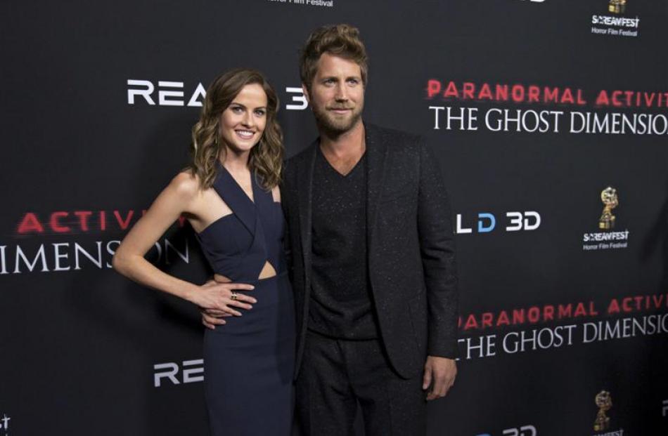 Cast members Chris J Murray and Brit Shaw pose at the premiere of "Paranormal Activity: The Ghost...