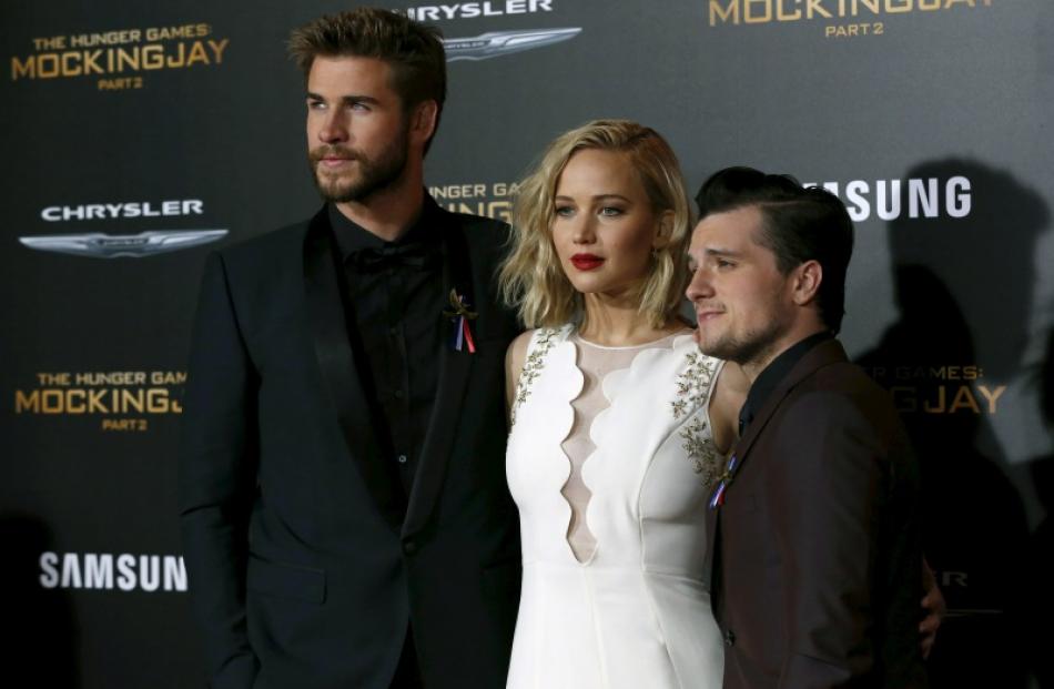 Cast members Liam Hemsworth, Jennifer Lawrence and Josh Hutcherson pose at the premiere of "The...