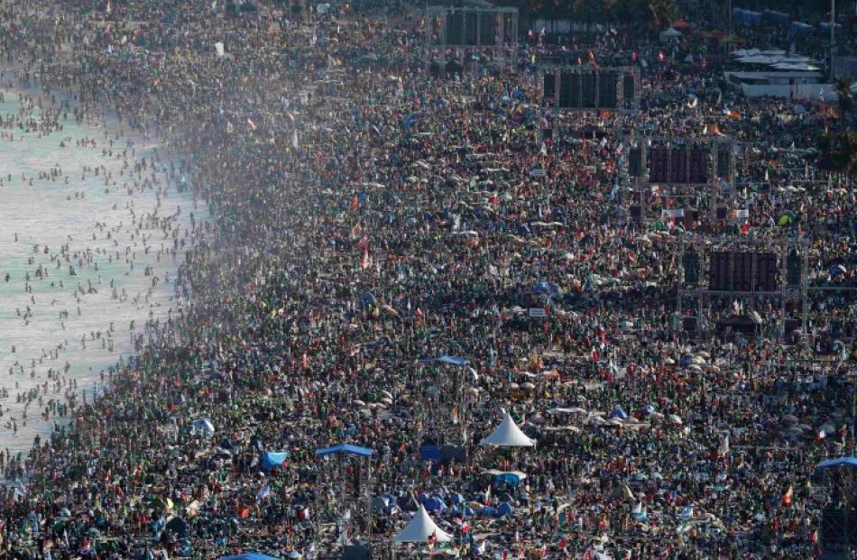 Catholic faithful camp out on Copacabana Beach to participate in an all-night vigil before Pope...