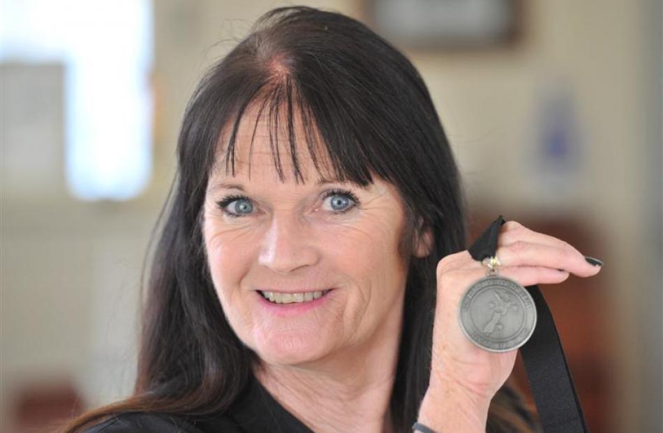 Cecilia Sullivan-Grant holds up the medal she was awarded as a Kiwibank Local Hero. Photo by...