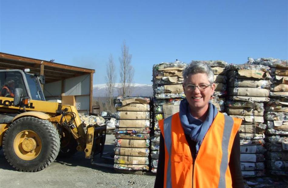 Central Otago Wastebusters, Alexandra, manager Sue Coutts in front of stacks of recyclables....