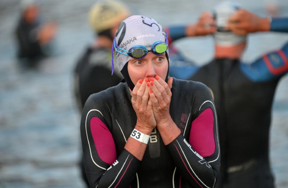 Carrie Lester, from Australia, warms her hands before the start at Challenge Wanaka on Saturday.