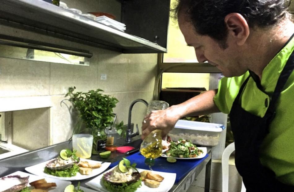 Chef Boris Panta in the kitchen at Paladar Vistamar platting red snapper ceviche. Photo: David Latt