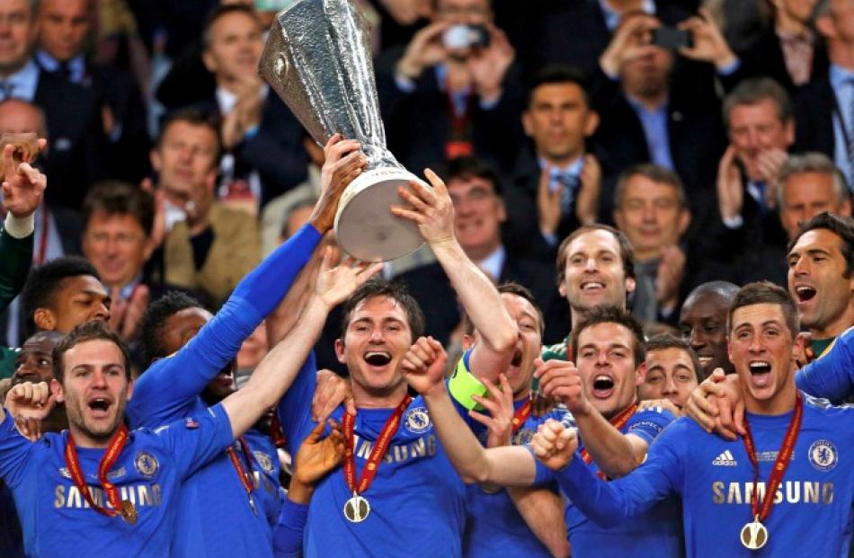 Chelsea players celebrate with the trophy after defeating Benfica in the Europa League final at...