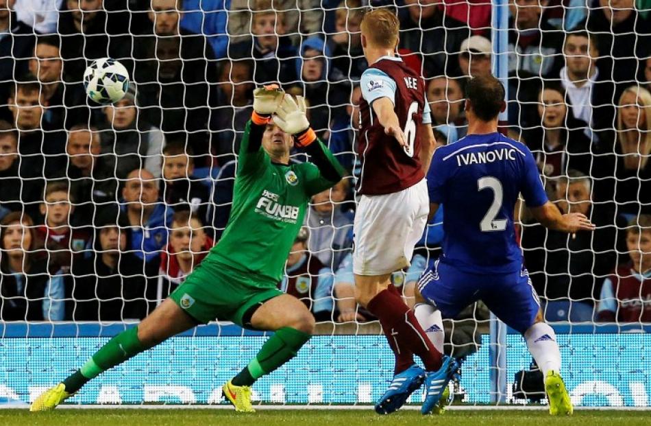 Chelsea's Branisiav Ivanovic (R) scores past Burnley goalkeeper Tom Heaton. REUTERS/Andrew Yates