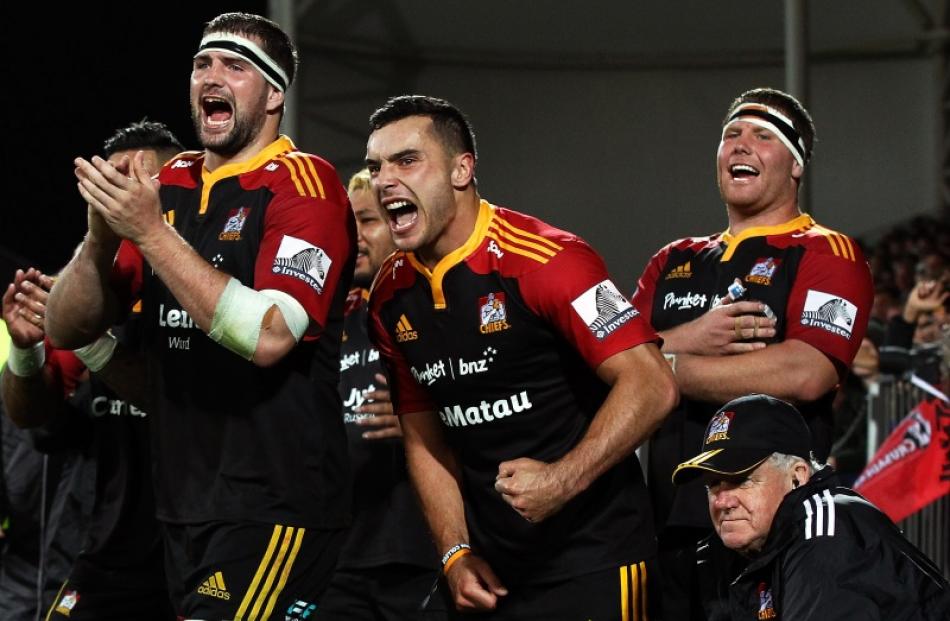 Chiefs team mates (L to R) Matt Symons, James Lowe and Mitchell Graham celebrate during the round...