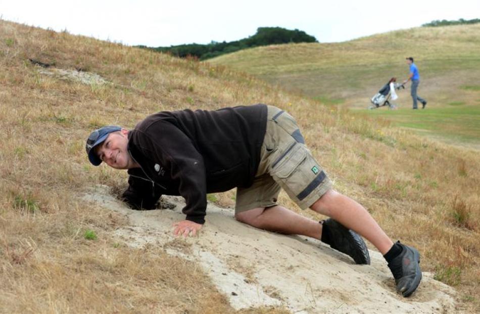 Chisholm Park Golf Club course superintendent Darrin Steedman checks out one of the many rabbit...