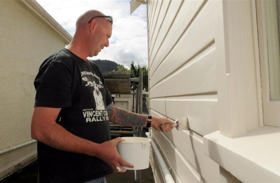 Chris Rhodes paints a student flat owned by Lyndon Clayton in Harbour Tce, Dunedin, yesterday....
