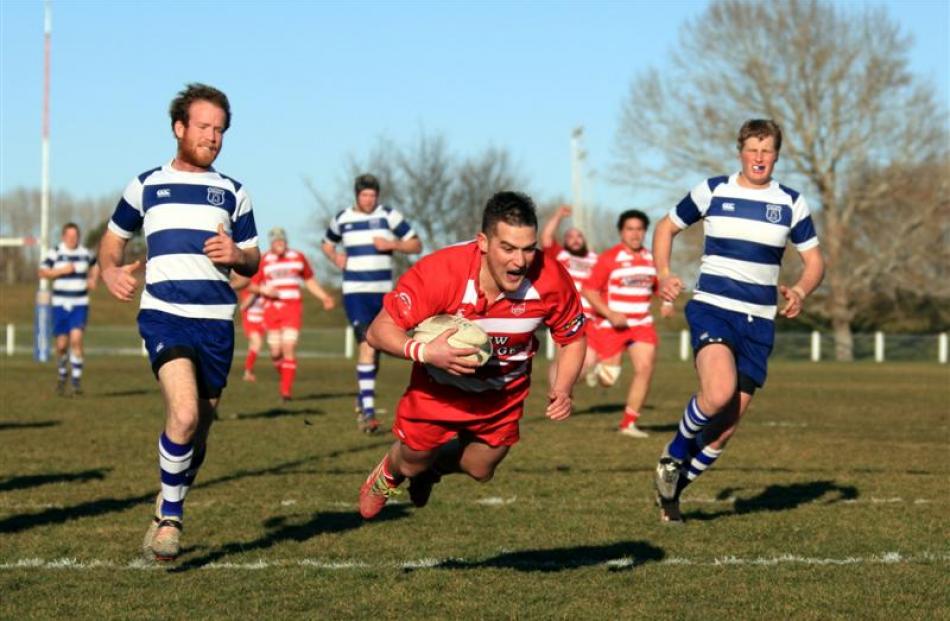 Clutha back Tyler Bichan dives over for a try during the South Otago premier club rugby final...