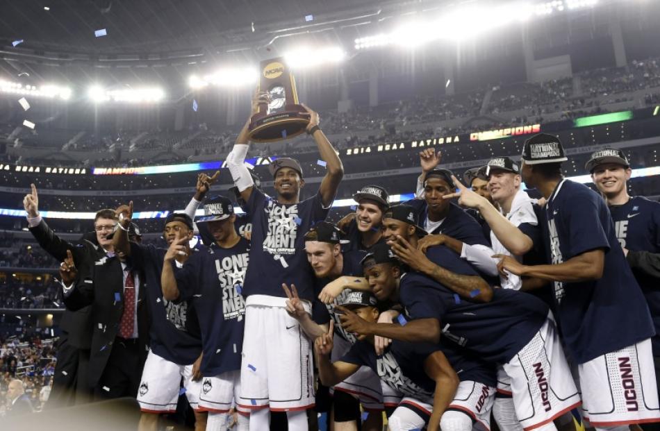 Connecticut Huskies forward DeAndre Daniels celebrates with the trophy after defeating the...