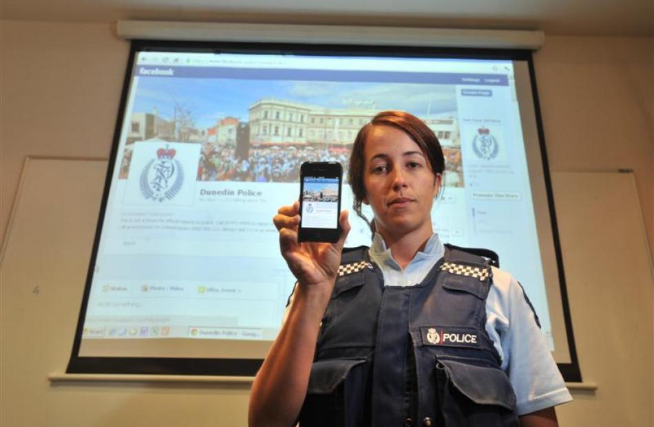 Constable Kristyn Adamson displays a smartphone and large screengrab of Dunedin police's new...