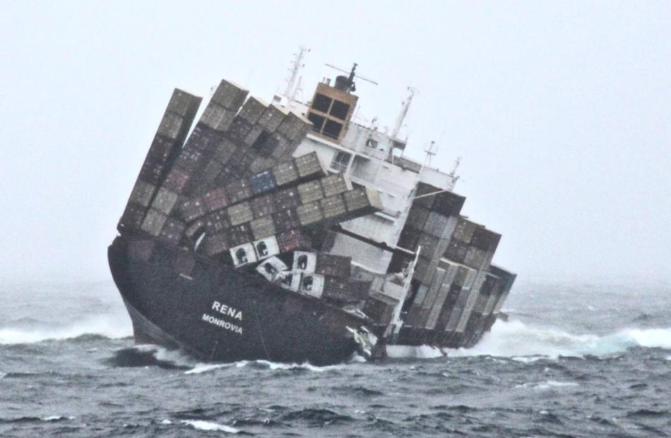 Containers tumble as the stricken vessel Rena lists to starboard this morning. Photo by NZDF