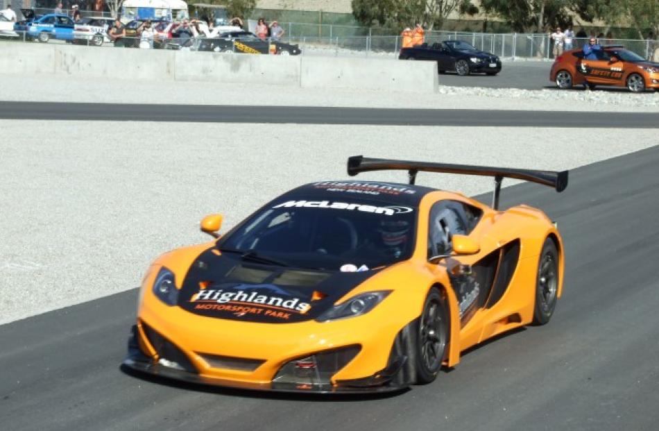 Craig Baird drives Highlands Motorsport Park owner Tony
...
