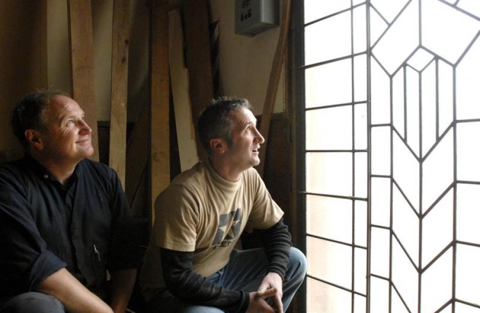 Craig McNaughton (left) and Lawrie Forbes inspect the original John McIndoe leadlight they found...