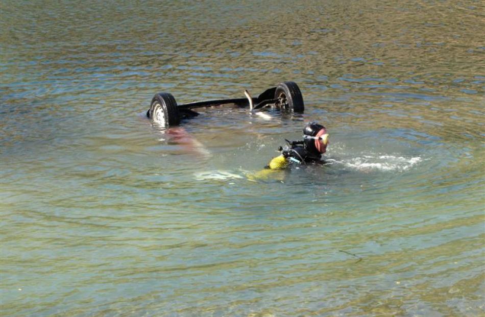 Cromwell diver Richard Wallis hooks a tow rope on to a Honda City in Lake Dunstan. Photos by...