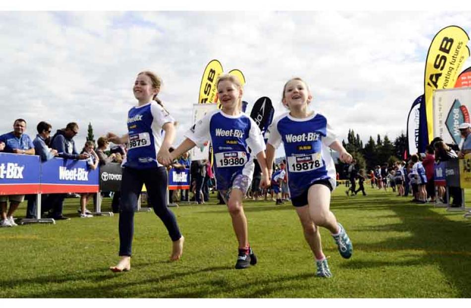 Crossing the line together are (from left) Chantal Lee (8), Ruby Wispinski (8) and Abby McMullan ...