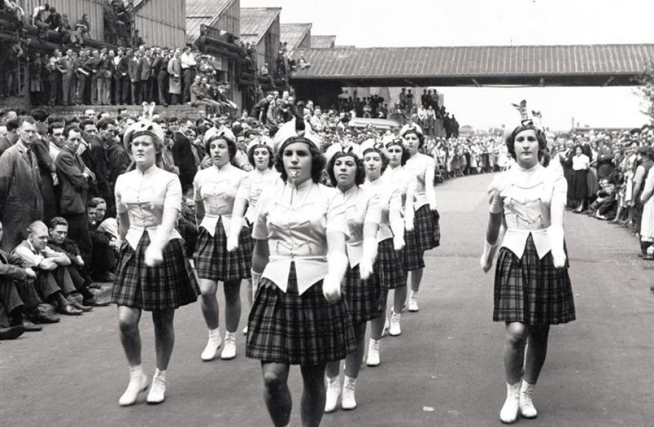 Crowds line the road in Birmingham to watch members of the Blair Atholl marching team in 1952