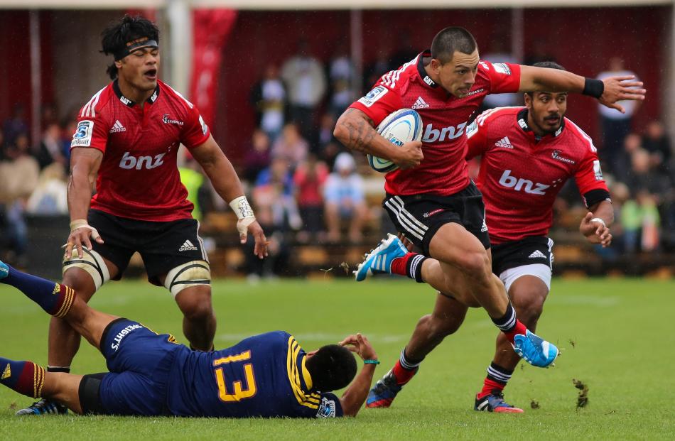 Crusaders winger Rob Thompson skips out of a tackle in a game against the Highlanders last year....