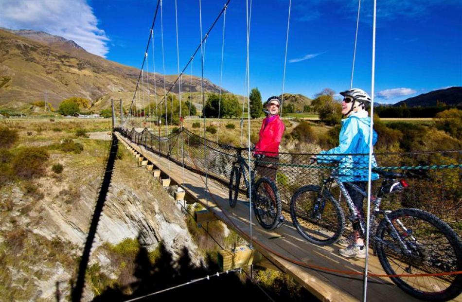 Cyclists admire the view from The Edgar Bridge on  the Queenstown Trail.  Concerns have been...