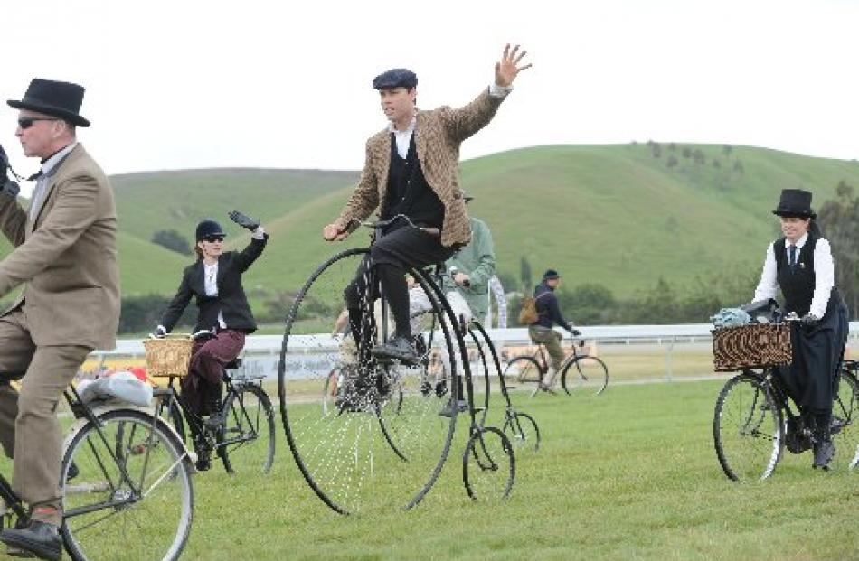 Cyclists Vanessa and Greg Davies wave to the crowd at Oamaru racecourse for the Heritage Raceday...