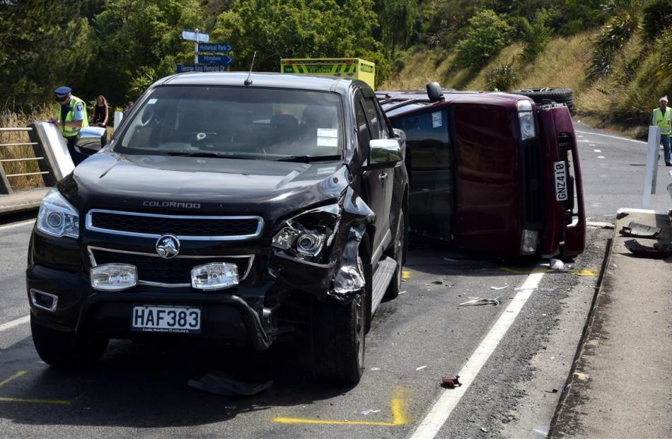 Damaged vehicles block SH87 after a two-vehicle crash near Outram yesterday. Photo by Craig Baxter.