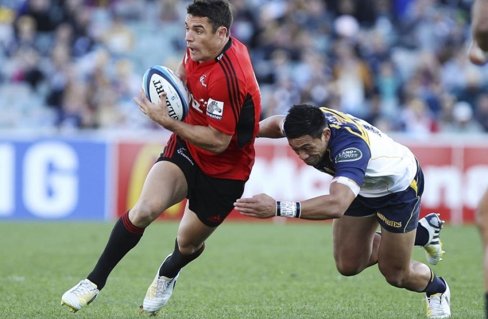 Dan Carter of the Crusaders is tackled during the round 12 Super Rugby match between the Brumbies...