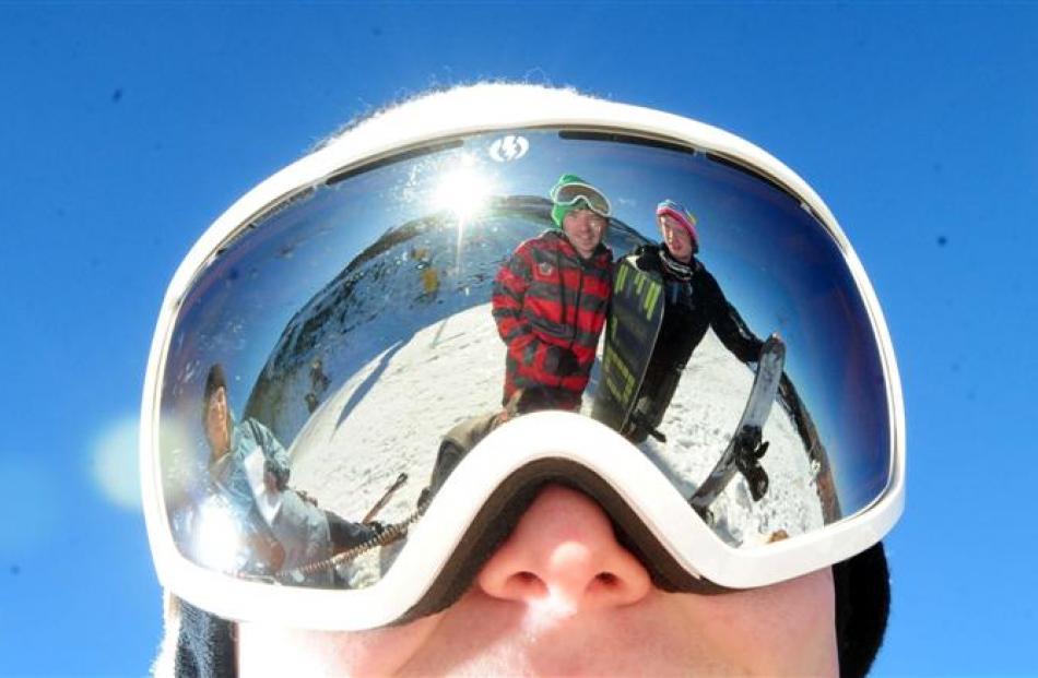 Dan O'Leary and Steven Forder reflected in Andy Golding's ski goggles  at Coronet Peak. Photo by...