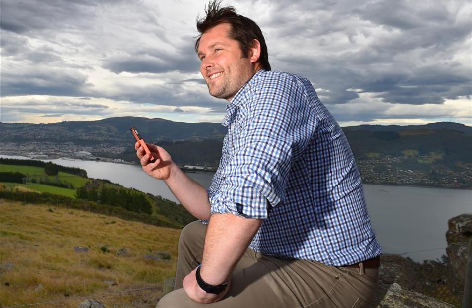 Danny Healy checks his new app at the Otago Peninsula Fallen Soldiers’ Memorial. Photo by Gregor...