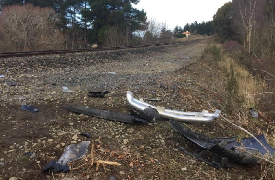 Debris from the crash lies beside the train track. Photos Chris Morris