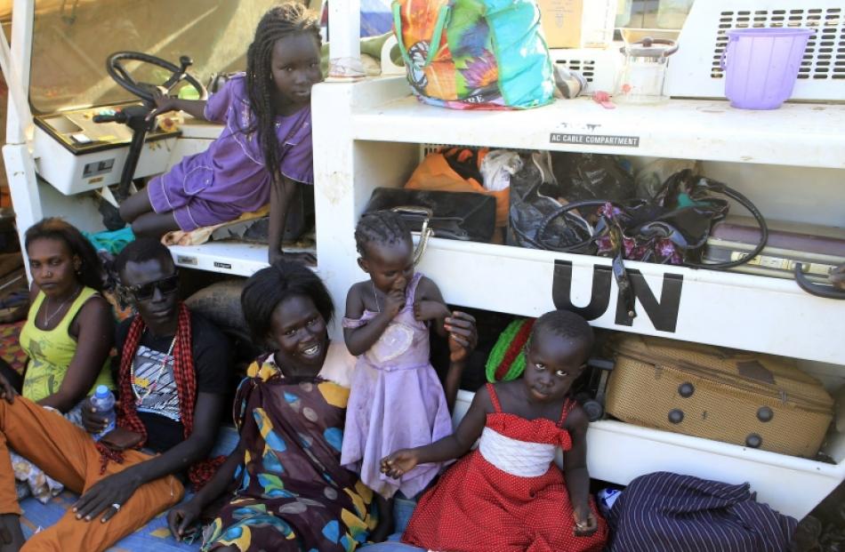 Displaced families are seen camped inside Tomping UN base near Juba international airport. Photo...