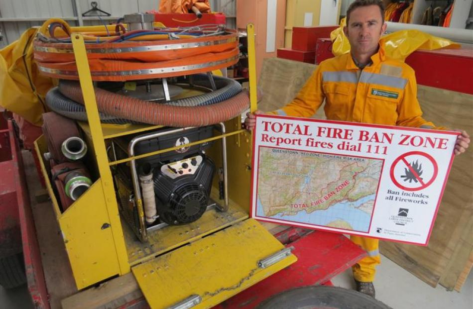 Doc Wakatipu rural fire officer Jamie Cowan stands beside a medium volume helibox pump, used to...