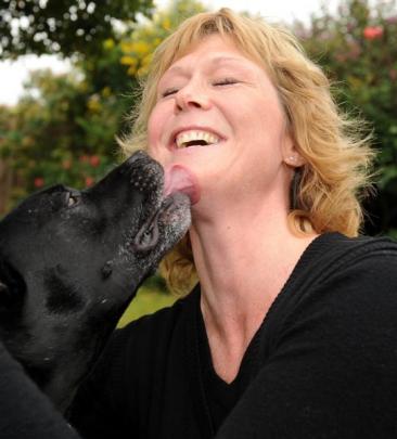 Dog-lover Sharon McNeill shares a kiss with Staffordshire bull terrier Bronx at her Brockville...
