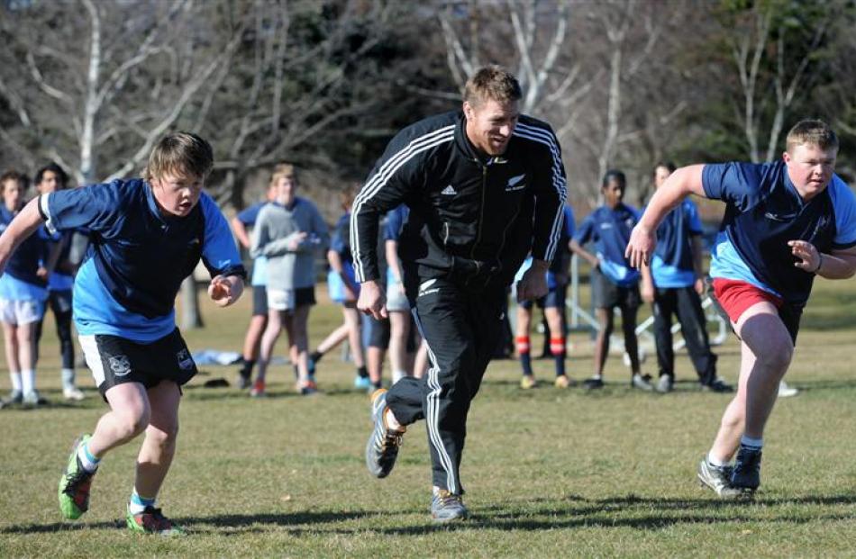 Doing a running drill with Brad Thorn during an All Black visit to Cromwell yesterday are...