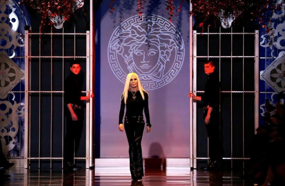 Donatella Versace acknowledges the audience at the end of the Versace Autumn/Winter 2014...