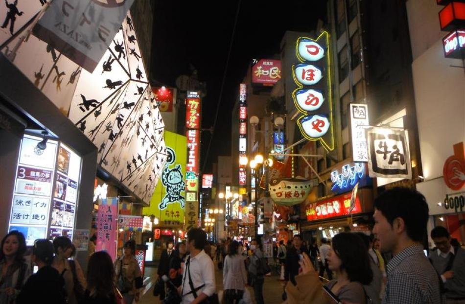 Dotonbori, a long, narrow street containing a high concentration of restaurants.It is rough-and...