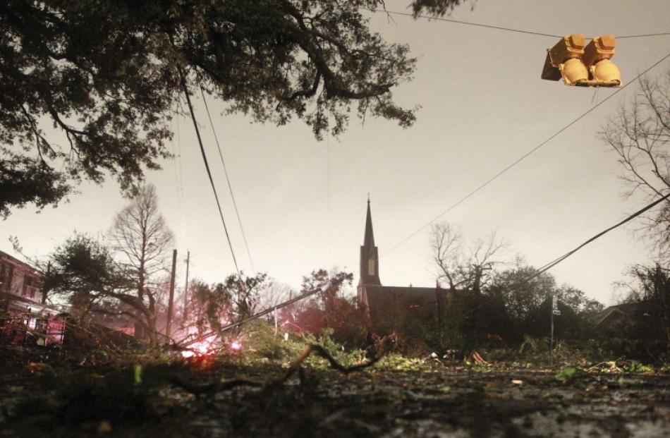 Downed trees and power lines along with a damaged traffic light caused by a Christmas Day tornado...