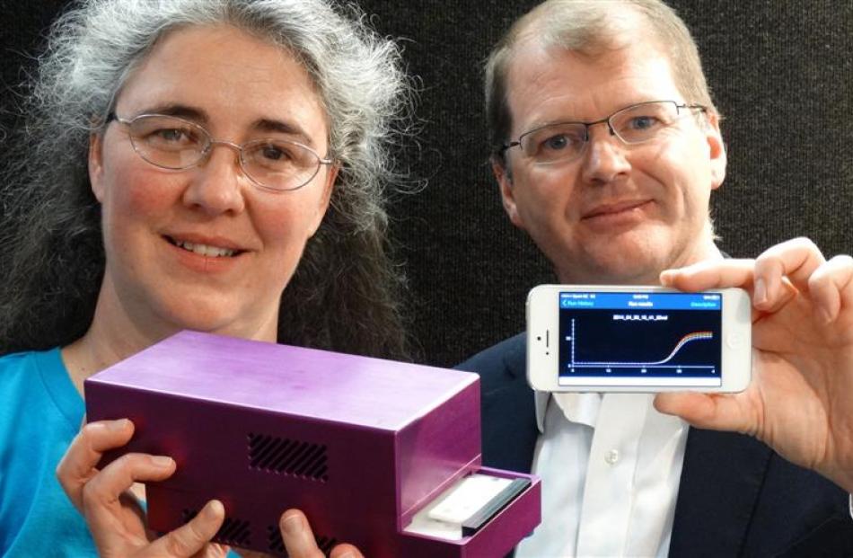 Dr Jo-Ann Stanton and Paul Pickering with a handheld DNA diagnostic unit, connected to a...