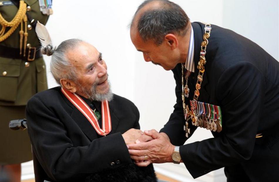 Dunedin artist Ralph Hotere is congratulated by New Zealand Governor-General Sir Jerry Mateparae...