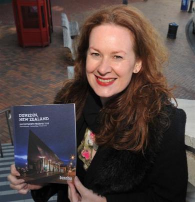 Dunedin City Council business development adviser Chanel O'Brien with a copy of a new Dunedin...