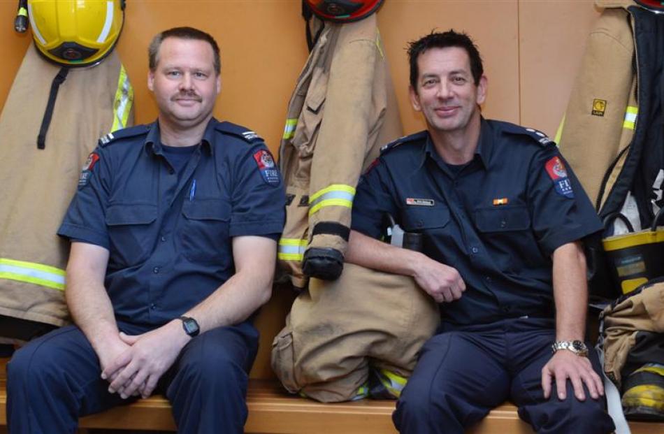 Dunedin firefighters Nigel Manson (left) and Pete Douglas recently received their gold stars....