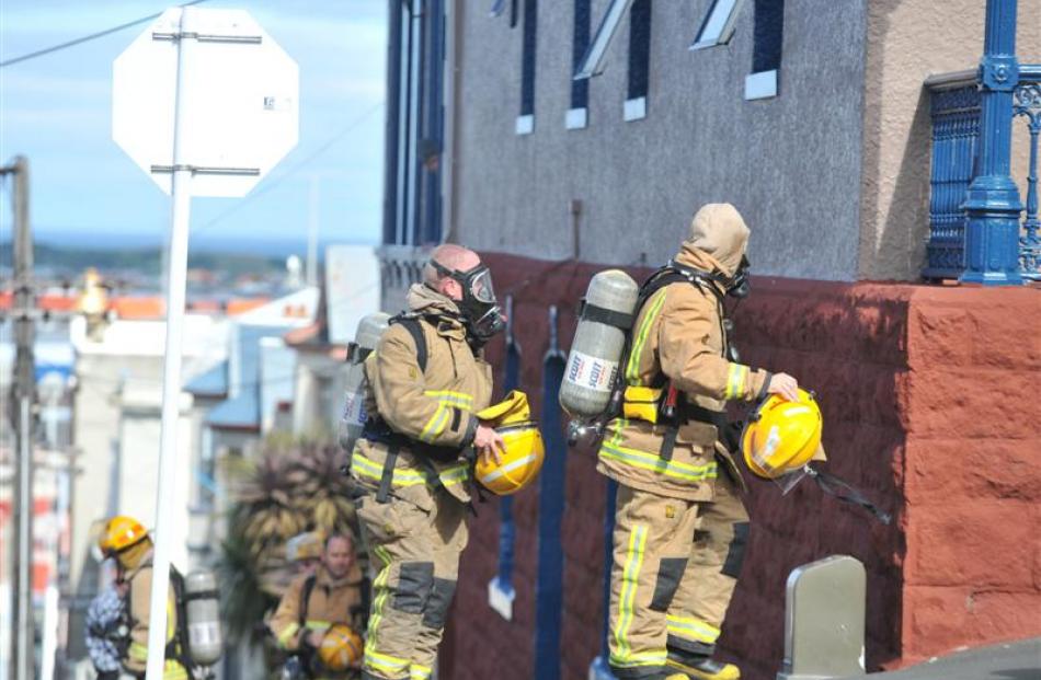 Dunedin firefighters with breathing apparatus prepare to enter a boarding house in High St...