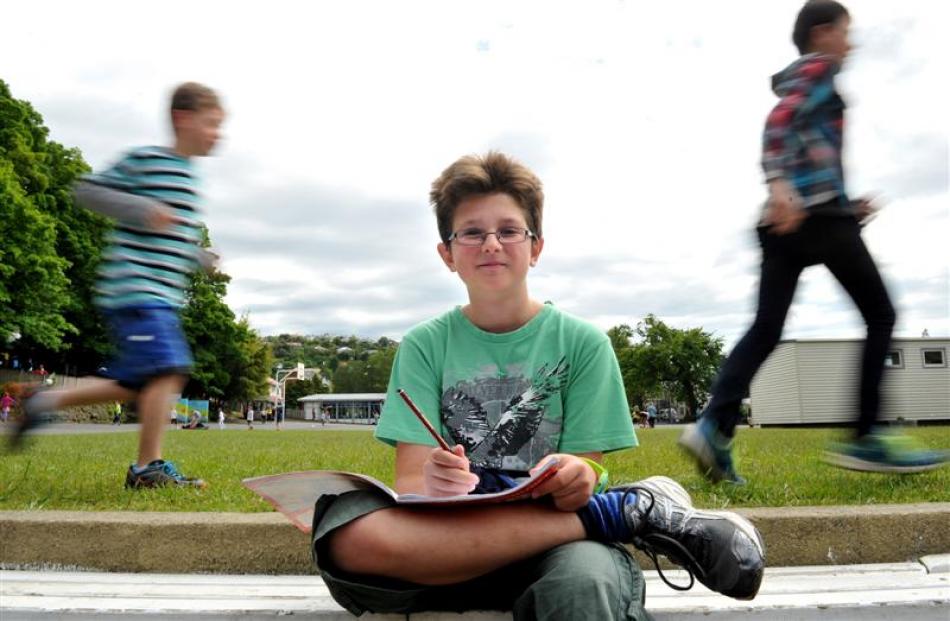 Dunedin George Street Normal School pupil Jasper Seddon contemplates his next story while his...