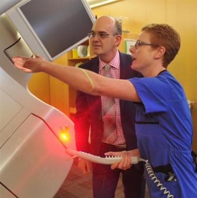 Dunedin Hospital senior radiation therapist Janine Ingham shows Health Minister Tony Ryall the...