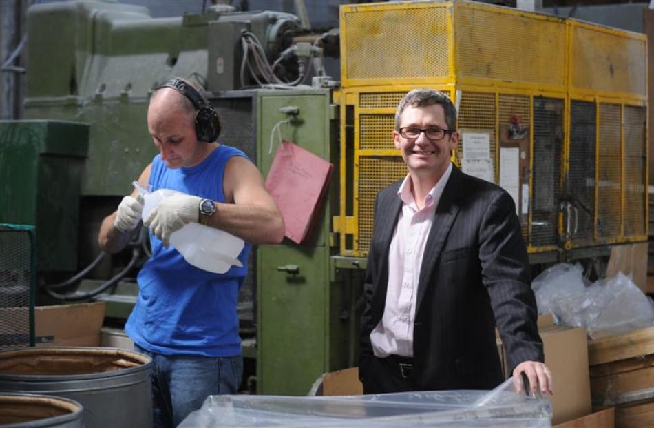 Dunedin manufacturer Norman Wood smiles as  employee Barry Gibbs creates plastic containers at...