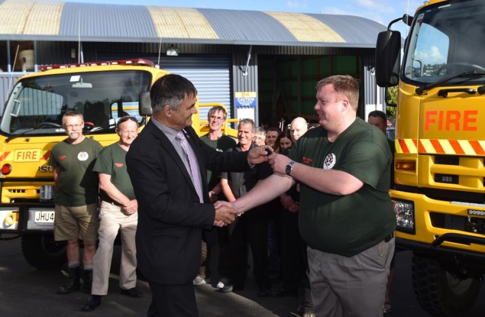 Dunedin Mayor Dave Cull (left) hands the keys to the new rural fire appliance to Wakari Volunteer...