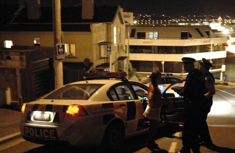 Dunedin police interview students outside a City Rise student flat after being called to an out...