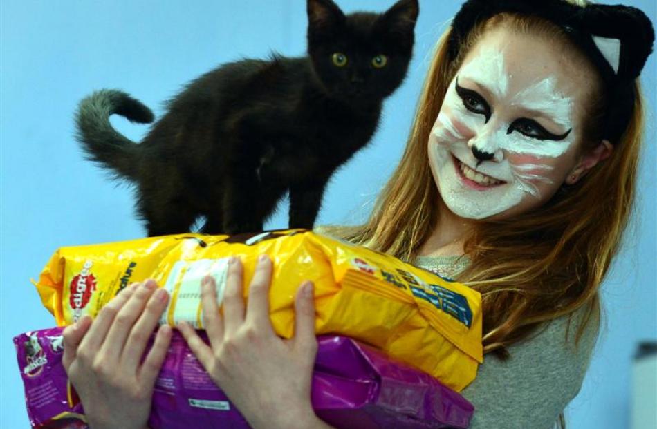 Dunedin pupil Grace Gardner (10) holds donated petfood and an SPCA kitten in Dunedin yesterday....
