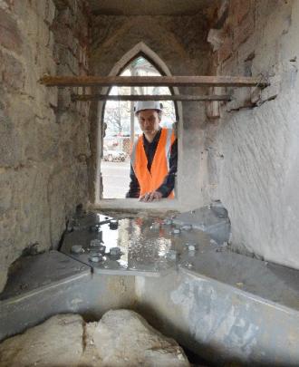 Dunedin stonemason Marcus Wainwright checks steel reinforcing beams inside Cargill's Monument in...